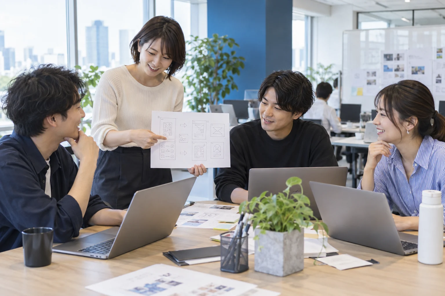 オフィスで課題を話し合う日本のチーム。AI生成の職場イメージ